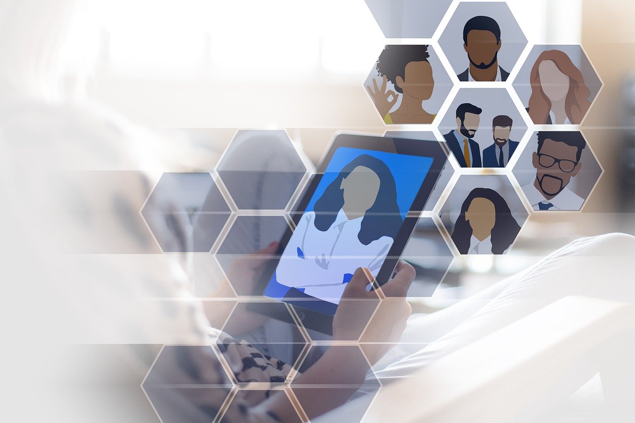 Laptop on a desk with a window view.